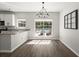 Bright dining area with hardwood floors, granite counters, and views of the backyard pool at 132 E Hartwick Ln, Goose Creek, SC 29445