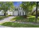 Charming two-story home with green shutters, well-maintained lawn, and a paved driveway at 132 E Hartwick Ln, Goose Creek, SC 29445