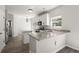 Well-lit kitchen with granite countertops, white cabinets, and stainless steel appliances at 132 E Hartwick Ln, Goose Creek, SC 29445