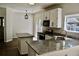 Bright kitchen with granite countertops, white cabinets, and stainless-steel appliances at 132 E Hartwick Ln, Goose Creek, SC 29445