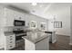 Open kitchen featuring an island, stainless steel appliances, granite countertops, and modern lighting at 132 E Hartwick Ln, Goose Creek, SC 29445
