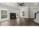 Spacious living room with a fireplace, ceiling fan, hardwood floors, and natural light at 132 E Hartwick Ln, Goose Creek, SC 29445