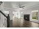 Bright living room with fireplace, ceiling fan, and large windows at 132 E Hartwick Ln, Goose Creek, SC 29445