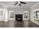 Cozy living room featuring a fireplace, ceiling fan, and lots of natural light at 132 E Hartwick Ln, Goose Creek, SC 29445