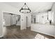 Open-concept living space with hardwood floors, kitchen bar, and modern light fixtures at 132 E Hartwick Ln, Goose Creek, SC 29445