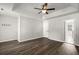 Comfortable main bedroom with wood floors, ceiling fan, and access to the ensuite bathroom at 132 E Hartwick Ln, Goose Creek, SC 29445