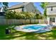 Backyard pool with a well-manicured lawn and a wooden fence providing privacy at 132 E Hartwick Ln, Goose Creek, SC 29445