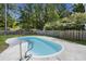 A private in-ground swimming pool surrounded by a concrete deck and a wooden fence at 132 E Hartwick Ln, Goose Creek, SC 29445
