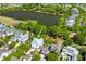 Stunning aerial view of a white two-story home near a tranquil lake and lush greenery at 1331 Smythe St, Daniel Island, SC 29492