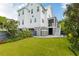 Expansive backyard featuring a lush lawn and a charming two-story white home at 1331 Smythe St, Daniel Island, SC 29492