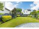 Well-manicured backyard offers a private outdoor space with green grass and tasteful landscaping at 1331 Smythe St, Daniel Island, SC 29492