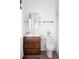 Modern bathroom with a wood vanity, and matching mirror, a white toilet, and a shower with glass doors at 1331 Smythe St, Daniel Island, SC 29492