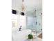 Bright bathroom featuring a standalone tub, glass shower with marble tile, and a modern starburst light fixture at 1331 Smythe St, Daniel Island, SC 29492