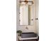Bathroom vanity features a grey sink, warm toned walls, and stylish sconces at 1331 Smythe St, Daniel Island, SC 29492