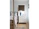 The primary bedroom has a white dresser with gold hardware and a woven window shade at 1331 Smythe St, Daniel Island, SC 29492