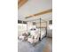 Bedroom with four poster bed, wood beams, accent wall, and sitting area at 1331 Smythe St, Daniel Island, SC 29492