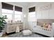 Bedroom with neutral wallpaper, white trim, a large window, and a white crib at 1331 Smythe St, Daniel Island, SC 29492