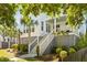 Inviting home with stairs leading to a covered porch, mature landscaping, and a swing at 1331 Smythe St, Daniel Island, SC 29492