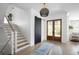 Bright foyer featuring wooden staircase, shiplap accent wall, and sliding barn door at 1331 Smythe St, Daniel Island, SC 29492