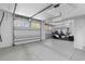 Spacious garage with epoxy flooring, bright lighting, and a four-seat golf cart at 1331 Smythe St, Daniel Island, SC 29492