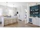 Open kitchen design with white cabinetry, stainless steel appliances, and a full bar at 1331 Smythe St, Daniel Island, SC 29492