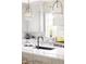 Clean kitchen featuring white cabinets, quartz countertops, and a stylish sink at 1331 Smythe St, Daniel Island, SC 29492