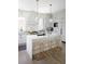 Bright kitchen with a white island, sleek stools, and pendant lighting at 1331 Smythe St, Daniel Island, SC 29492