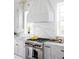 Clean white kitchen featuring stainless steel stove and stunning backsplash at 1331 Smythe St, Daniel Island, SC 29492