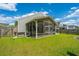 This backyard features a screened-in porch, lush green lawn, and privacy fence at 137 Clydesdale Cir, Summerville, SC 29486