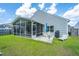 Backyard features a screened-in porch, patio and well-manicured lawn, perfect for entertaining at 137 Clydesdale Cir, Summerville, SC 29486
