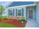 Charming home featuring a welcoming front yard with stone accents and a decorative wreath on the front door at 137 Clydesdale Cir, Summerville, SC 29486