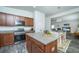 Well-equipped kitchen featuring modern stainless steel appliances, granite countertops, and dark wood cabinets at 137 Clydesdale Cir, Summerville, SC 29486