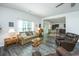 Cozy living area merging with kitchen, featuring hardwood floors, neutral decor, and a view to the backyard at 137 Clydesdale Cir, Summerville, SC 29486