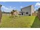 Large backyard featuring a playset, lush lawn, and a shaded pergola at 138 Sweet Cherry Ln, Summerville, SC 29486