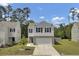 Charming two-story home featuring a gray and white exterior, complemented by a well-maintained front yard at 138 Sweet Cherry Ln, Summerville, SC 29486