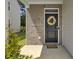 Close up view of the front door with a wreath, brick exterior, and a welcoming door mat at 138 Sweet Cherry Ln, Summerville, SC 29486