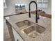 Granite island kitchen with a modern faucet, undermount sink, and stainless dishwasher at 138 Sweet Cherry Ln, Summerville, SC 29486