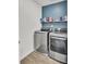 Laundry room featuring stainless steel washer and dryer, complete with overhead shelving at 138 Sweet Cherry Ln, Summerville, SC 29486