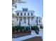Elegant home with a metal roof, a welcoming front porch, and well-maintained landscaping at 1449 Jeremy Cay Ct, Awendaw, SC 29429