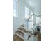Stairway with wooden treads, white risers, and bright natural lighting at 1449 Jeremy Cay Ct, Awendaw, SC 29429
