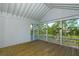 Spacious screened porch with wood flooring and panoramic views of surrounding landscape at 1449 Jeremy Cay Ct, Awendaw, SC 29429