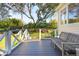 Inviting back deck with white railing overlooks the lawn and mature trees, perfect for outdoor living at 1511 Fairway Dr, Charleston, SC 29412