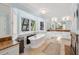 Bright, oversized bathroom with dual vanities, a soaking tub, a fireplace, and large windows for lots of natural light at 1511 Fairway Dr, Charleston, SC 29412