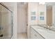 Well-lit bathroom featuring marble counters, stylish mirror and shower with glass door at 1511 Fairway Dr, Charleston, SC 29412