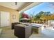Charming covered patio with comfortable seating overlooking the backyard pool and mature trees at 1511 Fairway Dr, Charleston, SC 29412