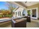 Relaxing covered patio with plush seating, offering a view of the lush backyard and well-maintained home exterior at 1511 Fairway Dr, Charleston, SC 29412