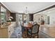 Well-lit dining room featuring a large table, elegant chairs, and a view of the home's entryway at 1511 Fairway Dr, Charleston, SC 29412
