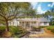 Charming two-story home with a welcoming front porch, mature trees, and landscaped front yard at 1511 Fairway Dr, Charleston, SC 29412