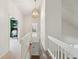 Upstairs hallway features white walls, a modern light fixture, access to a bedroom and office, and wood stairs at 1511 Fairway Dr, Charleston, SC 29412
