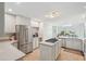 Well-lit kitchen featuring stainless steel appliances, a center island, and tiled floors at 1511 Fairway Dr, Charleston, SC 29412
